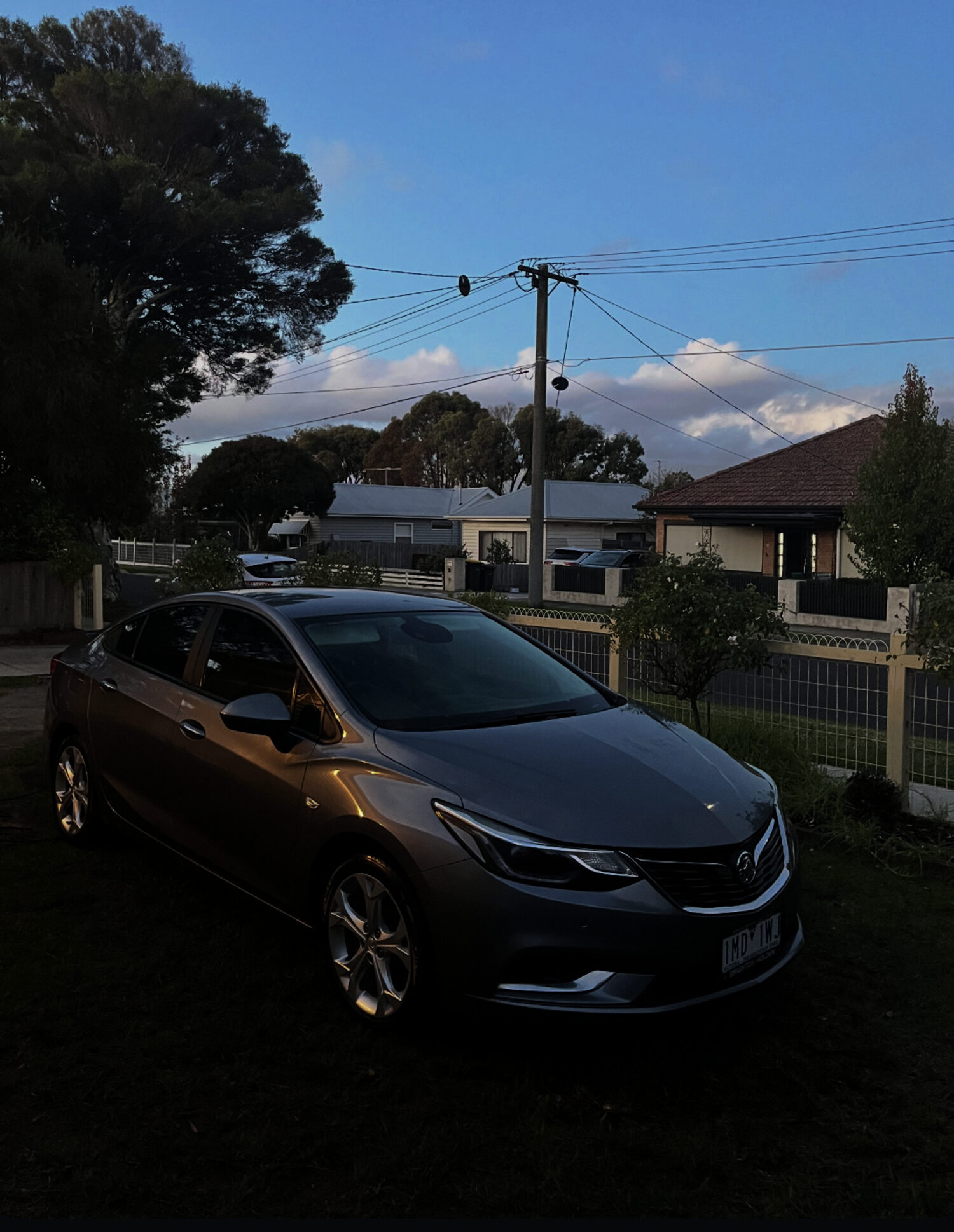 Freshly detailed grey sedan, glossy paintwork, in a Geelong driveway