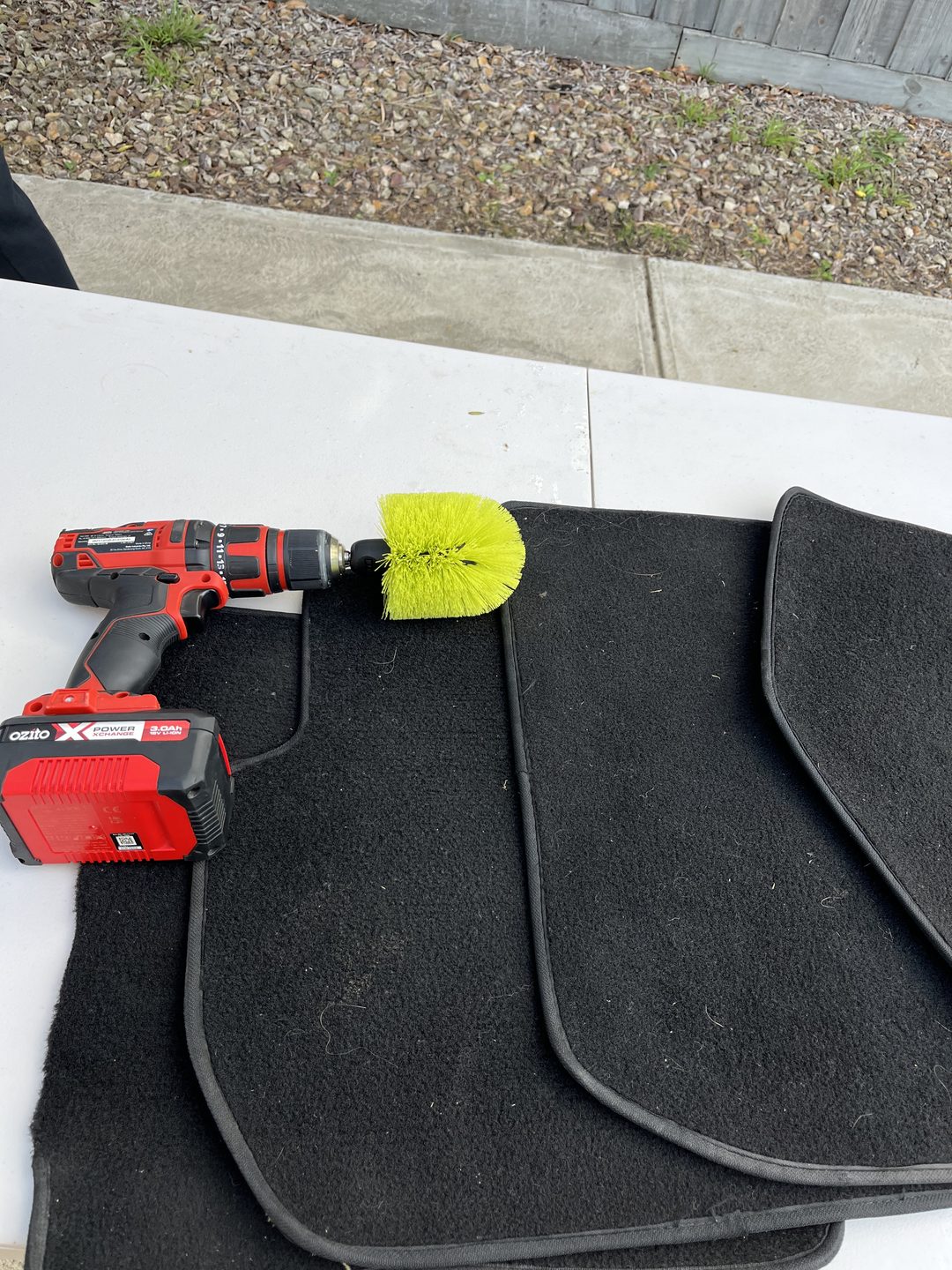 Muddy car floor mats deep cleaned with a drill brush in Geelong
